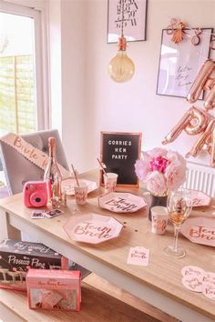 the table is set with pink and gold decorations