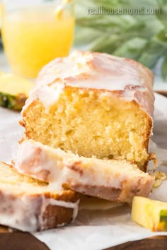 a loaf of lemon pound cake with icing and sliced pineapples on the side