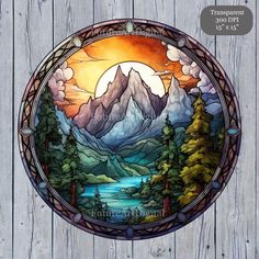 a stained glass window with mountains and trees in the background on a wooden wall,