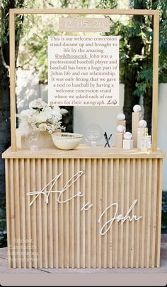 a sign that says it's ok on the side of a wooden table with flowers and candles