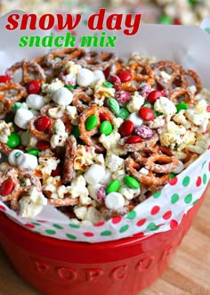 a red bowl filled with candy and pretzels