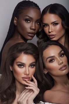 three beautiful women posing for the camera with their hands on their chins and one woman's face