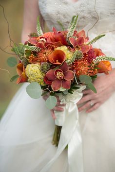 a bride holding a bouquet of flowers in her hands