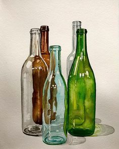 three different colored glass bottles sitting next to each other