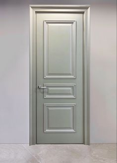 an open door in a room with white walls and floor tiles on the floor,