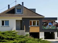 a house with a garage and stairs leading up to it