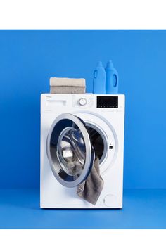 a white washer sitting on top of a blue floor