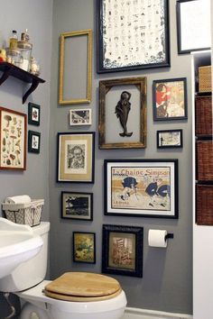 a bathroom with pictures on the wall and toilet