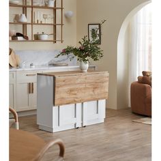 a kitchen with white cabinets and wooden counter tops