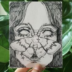 a drawing of a woman's face with her eyes closed and nose covered by leaves