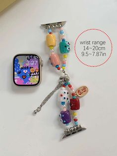 a cell phone charm is attached to a chain with an ice cream sandwich and other items