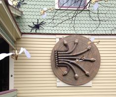 a clock on the side of a building with decorations hanging from it's sides