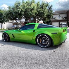 a green sports car parked in a parking lot