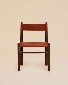 a wooden chair with brown leather seat and back