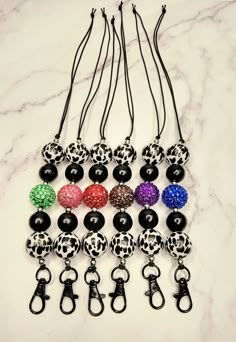 six pairs of black, white, and multicolored beaded key chains