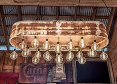 a chandelier hanging from the ceiling in front of a wooden structure with many light bulbs