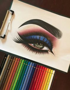 a drawing of an eye with colored pencils next to it