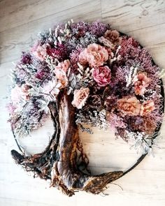 a tree that has been made out of flowers on the side of a wooden floor