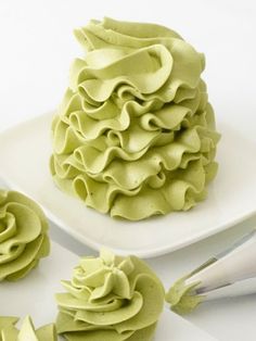 a cake with green frosting on a white plate