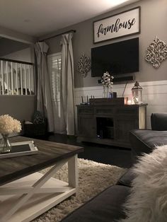 a living room filled with furniture and a flat screen tv mounted to the wall over a fireplace