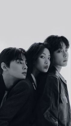 three young people are posing for a photo in front of a white background with black and white