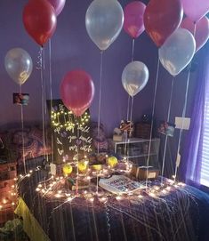 balloons are floating in the air over a table