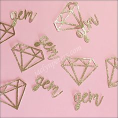 some gold glitter stickers on a pink background