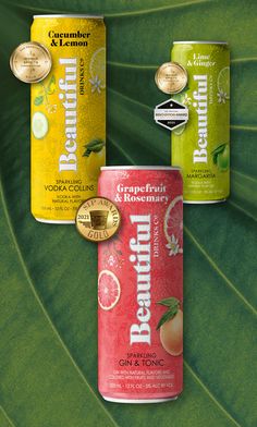 three cans of peach tea on a green leaf