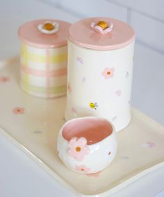 two pink and white containers sitting on top of a tray