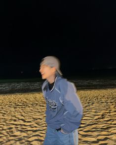 a man standing on top of a sandy beach