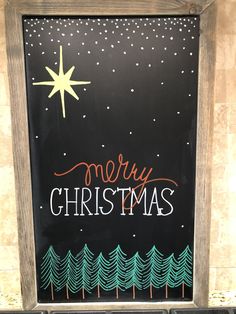 a chalk board with christmas written on it