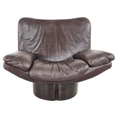 a brown leather chair sitting on top of a metal base