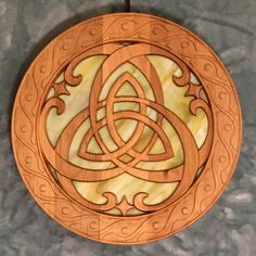 a wooden plate with an intricate design on it