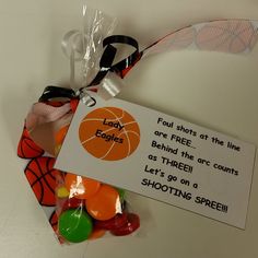 a bag filled with lots of candy sitting on top of a white table next to a sign