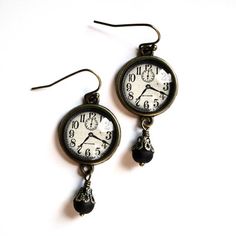 Our Edwardian clock earrings are a subtle nod to steampunk.  Cool enough to finish off your best cosplay, but subtle enough to be worn with your every day attire.  The image was scanned from a turn of the century dry-goods catalog and formatted especially for our clean bronze findings.Image area 5/8" (about the size of a dime)Total Length approximately 1.5" including accent bead.  Bead style may vary slightly from batch to batch.Wires and setting are nickel-free brass. Dark Academia Ear Piercings, Clean Bronze, Clock Earrings, Maddie Hatter, Silly Earrings, Cottage Core Jewelry, Honey Bee Earrings, Steampunk Clock, Victorian Vintage