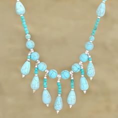 a necklace with turquoise stones and silver beads