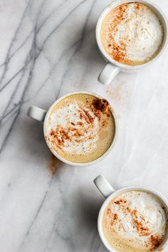 three cups of hot chocolate with cinnamon sprinkles