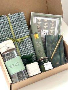 an open box containing various items such as candles, books and other personal care products