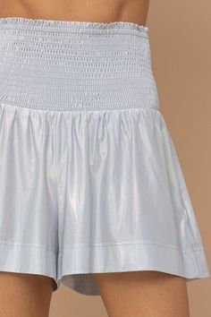 These Dreamer Smocked Waist Metallic Shorts are the perfect addition to your wardrobe. They feature a smocked waistband for a comfortable fit, and a metallic finish for a touch of glamour. The shorts are made from a lightweight fabric, making them perfect for summer days. They look great paired with a crop top and sandals for a casual look, or dress them up with a blouse and heels for a night out. PRODUCT DETAILS: Relaxed Fit Silhouette Colors May Vary Patterns May Vary CONTENT + CARE: 100% Poly Metallic Stretch Bottoms With Elastic Waistband, Casual Metallic Bottoms With Elastic Waistband, Casual Metallic Shorts For Spring, Metallic Shorts, Fabric Making, Cold Air, Women Clothing Boutique, Online Womens Clothing, Lightweight Fabric