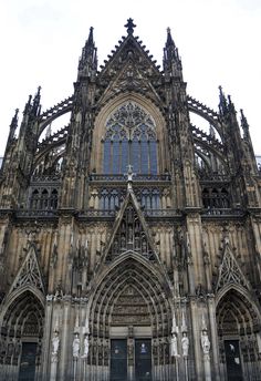 an old cathedral with statues on the front