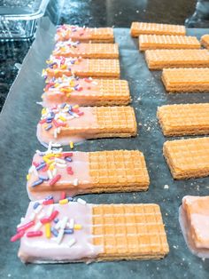 some waffles with frosting and sprinkles on them are lined up