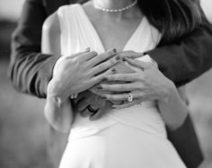 a man and woman holding each other's hands while standing next to each other