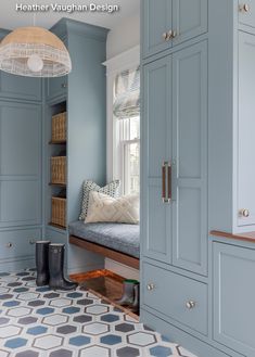 a room with blue cabinets and a bench