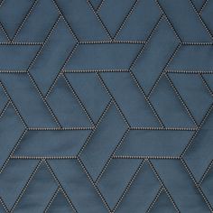 a close up view of a blue fabric with diamond stitching