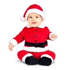 a baby in a santa suit sitting on the floor with his hands out and looking at the camera