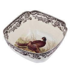 a bowl with a bird painted on the side and an ornate border around the edge