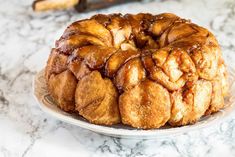 a bundt cake sitting on top of a plate covered in caramel glaze