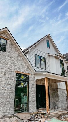 a house under construction with the front door open and windows still in place on the second floor