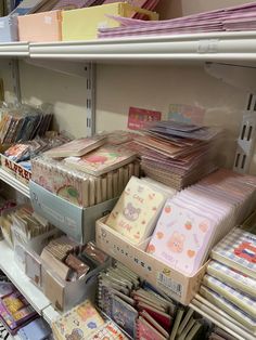 the shelves are filled with many different types of greeting cards and envelopes for sale