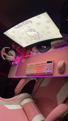 a desk with a keyboard, mouse and hello kitty wallpaper on the back side